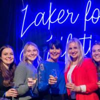 President Mantella smiles and holds up glass at Toast